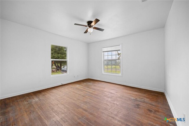 1304 E French Ave, Temple, TX 76501 - spare room with plenty of natural light, hardwood / wood-style flooring, ceiling fan, and baseboards