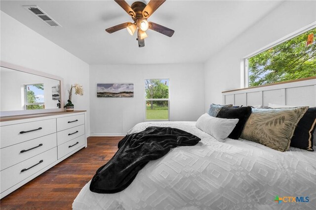 1304 E French Ave, Temple, TX 76501 - bedroom featuring multiple windows, dark wood finished floors, and baseboards