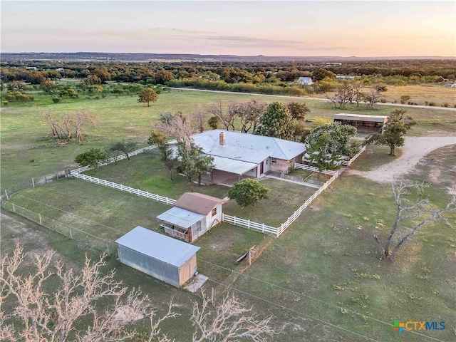 aerial view at dusk featuring a rural view