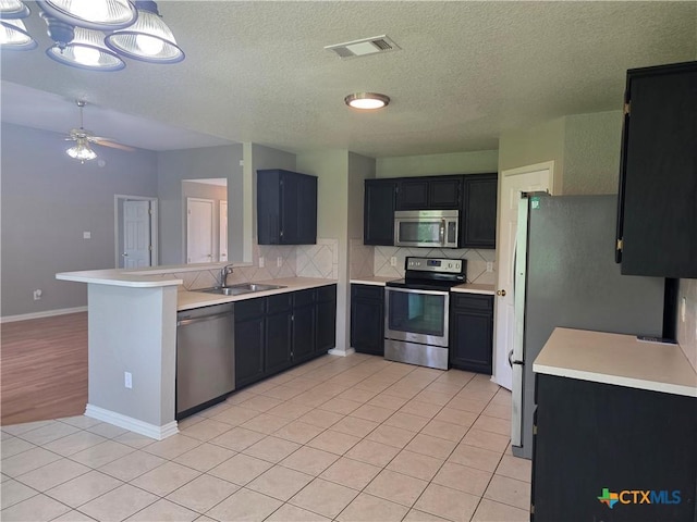 2803 Lindsey Dr, Copperas Cove, TX 76522 - kitchen featuring stainless steel appliances, backsplash, light countertops, light tile patterned flooring, and ceiling fan