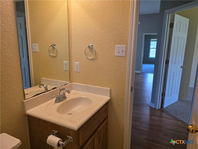 2803 Lindsey Dr, Copperas Cove, TX 76522 - half bathroom featuring a textured wall, wood finished floors, and vanity