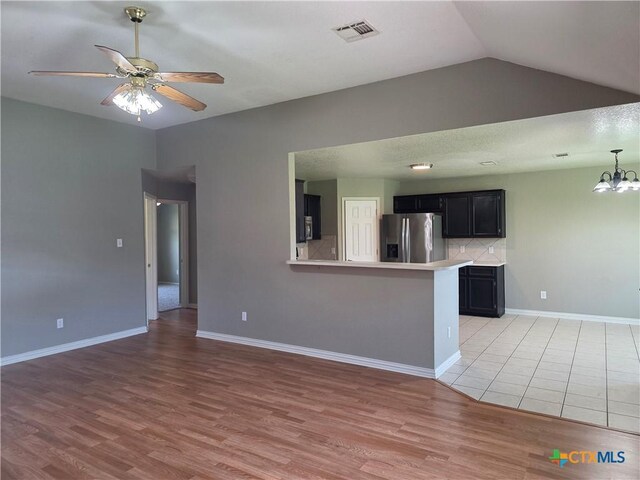 2803 Lindsey Dr, Copperas Cove, TX 76522 - kitchen featuring stainless steel fridge, dark cabinets, a ceiling fan, light wood finished floors, and light countertops