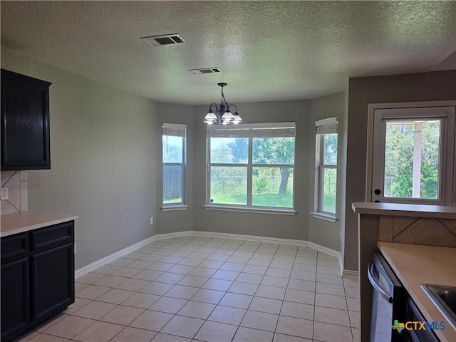 2803 Lindsey Dr, Copperas Cove, TX 76522 - unfurnished dining area featuring healthy amount of natural light, light tile patterned flooring, and a textured ceiling
