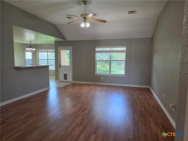 2803 Lindsey Dr, Copperas Cove, TX 76522 - unfurnished living room featuring lofted ceiling, healthy amount of natural light, wood finished floors, ceiling fan, and a chandelier