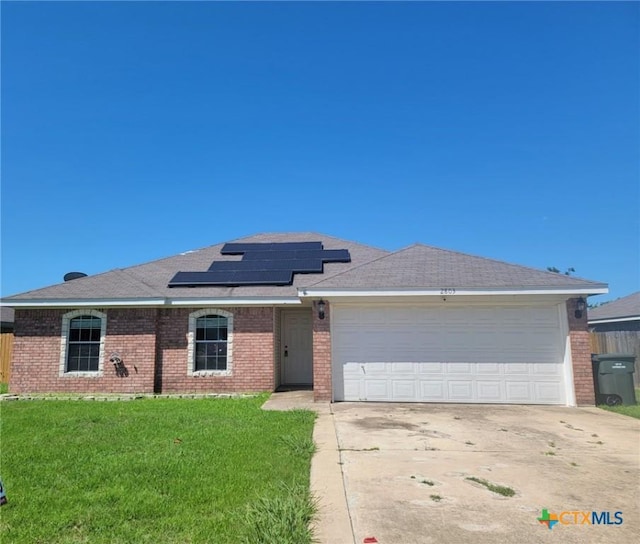 2803 Lindsey Dr, Copperas Cove, TX 76522 - ranch-style home featuring brick siding, roof mounted solar panels, concrete driveway, and a garage