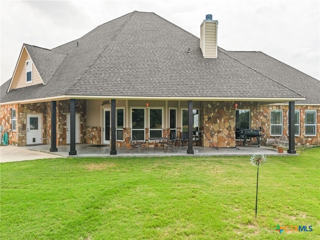 back of house with a yard and a patio area