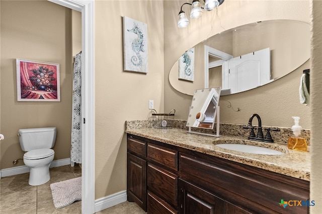 bathroom featuring tile patterned floors, vanity, and toilet