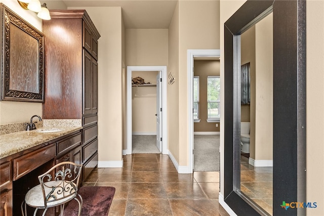 bathroom featuring vanity and toilet