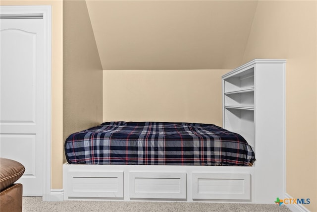 carpeted bedroom featuring lofted ceiling