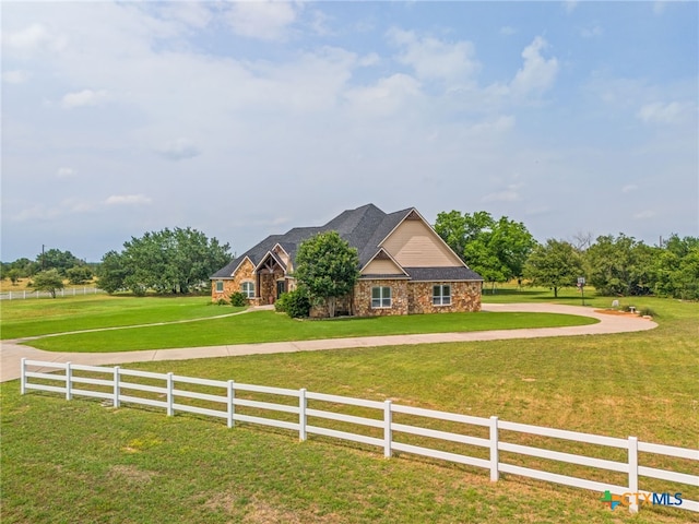 view of front facade with a front lawn and a rural view