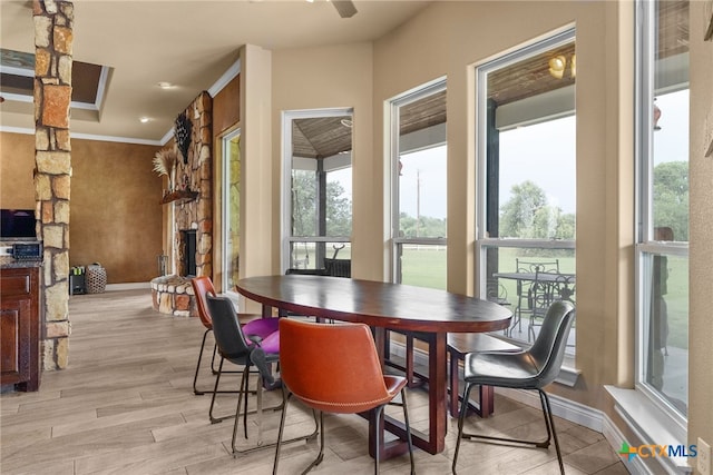 dining space featuring ornamental molding and light hardwood / wood-style floors