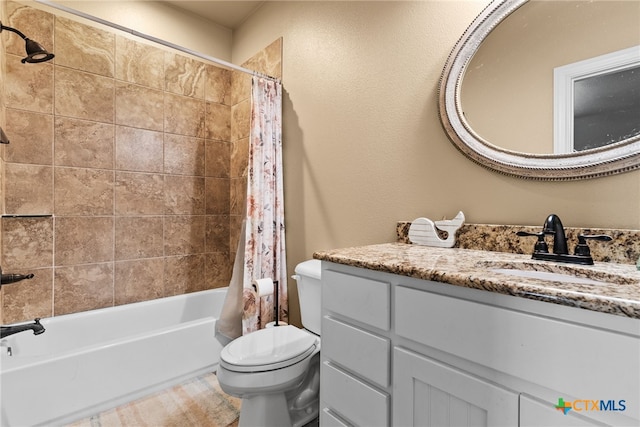 full bathroom with shower / tub combo with curtain, vanity, and toilet