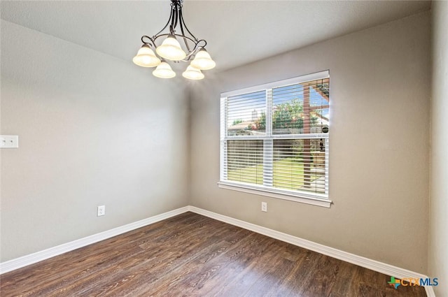 1617 Shadow Canyon Dr, Temple, TX 76502 - unfurnished room featuring dark wood finished floors and a chandelier