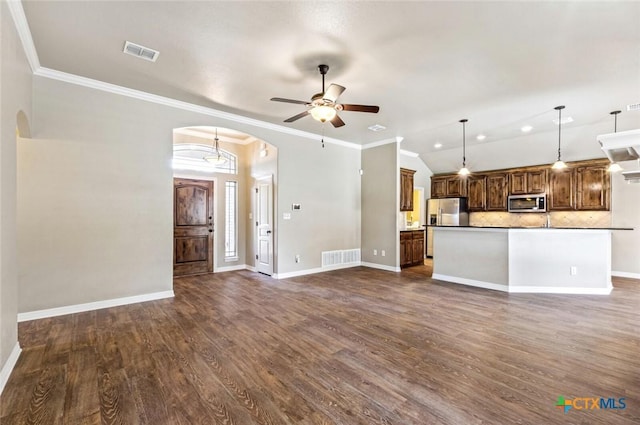 1617 Shadow Canyon Dr, Temple, TX 76502 - unfurnished living room featuring arched walkways, a ceiling fan, dark wood-style flooring, crown molding, and vaulted ceiling