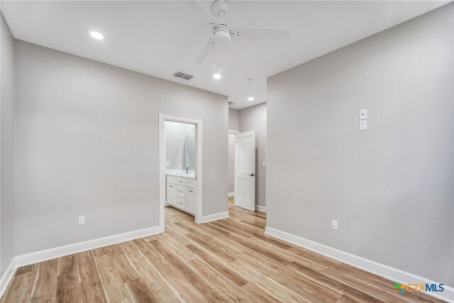 empty room with light hardwood / wood-style floors and ceiling fan