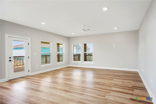 unfurnished room featuring ceiling fan and light hardwood / wood-style flooring