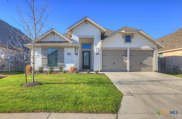 view of front of home with a garage and a front yard