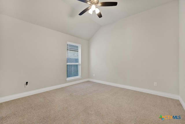 spare room with ceiling fan, lofted ceiling, and carpet