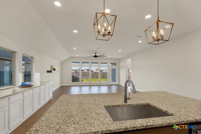 kitchen featuring lofted ceiling, sink, dark hardwood / wood-style floors, and hanging light fixtures