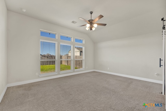 carpeted empty room with lofted ceiling and ceiling fan