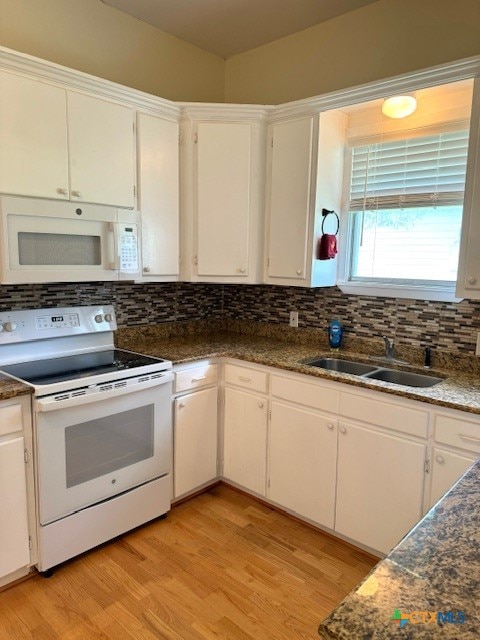 kitchen featuring white cabinets, light hardwood / wood-style flooring, sink, and white appliances