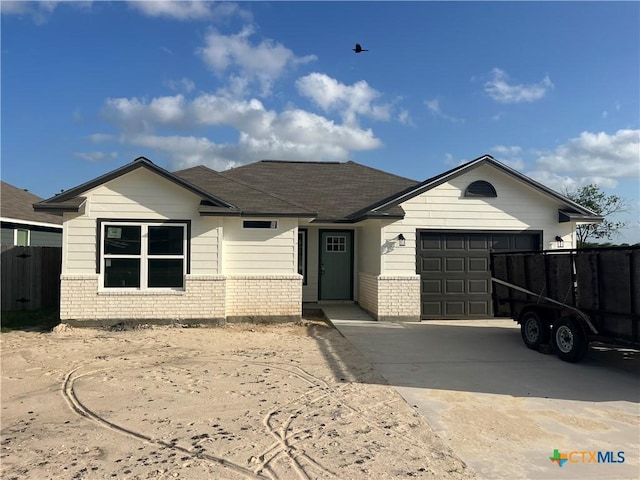 3503 Hanselman Rd, Victoria, TX 77901 - ranch-style home with brick siding, an attached garage, and driveway