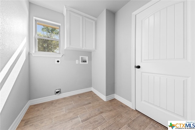 washroom featuring electric dryer hookup, cabinets, and washer hookup