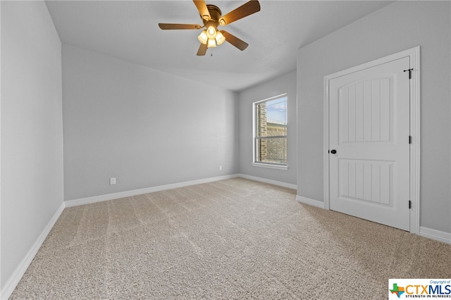 spare room with light carpet and ceiling fan