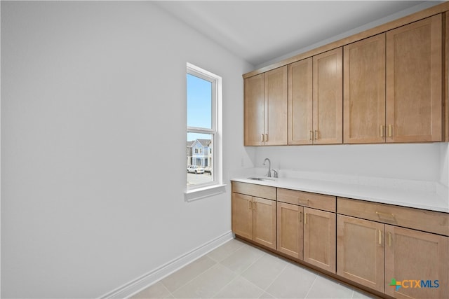 interior space with light tile patterned flooring and sink