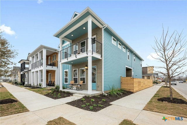 view of front of house with a balcony and covered porch