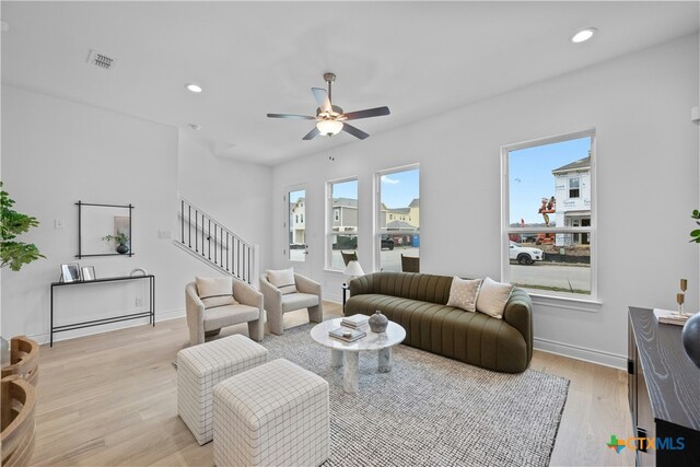 living room with ceiling fan and light wood-type flooring