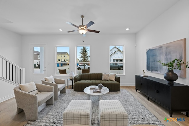 living room featuring ceiling fan and light wood-type flooring