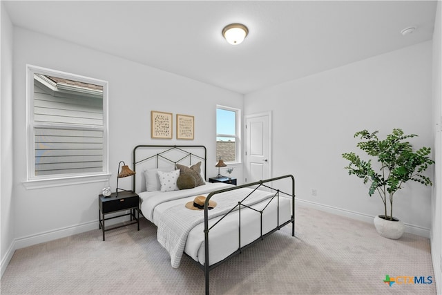 bedroom featuring light colored carpet