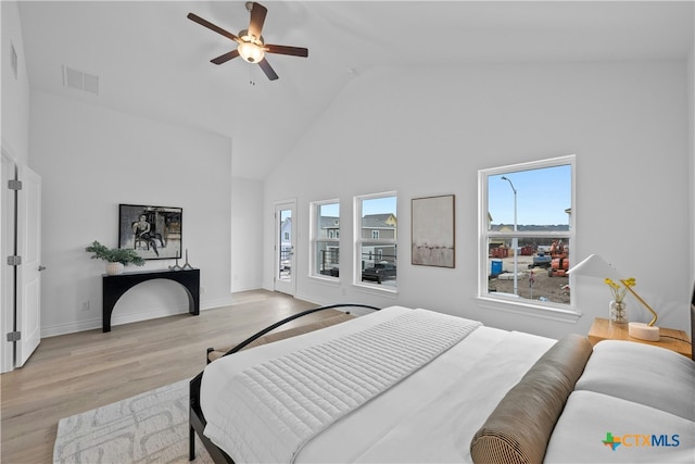 bedroom featuring high vaulted ceiling, ceiling fan, and light wood-type flooring