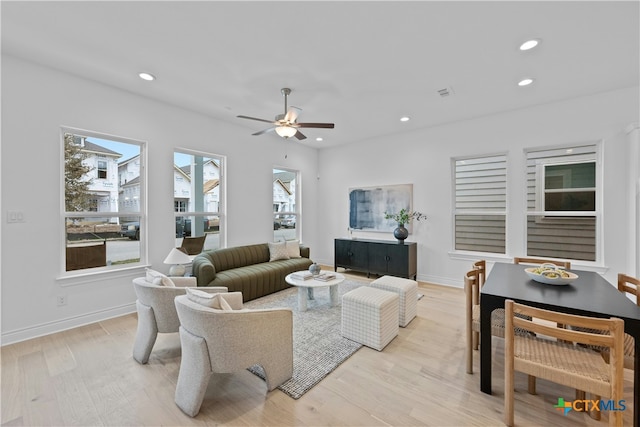living room with ceiling fan and light hardwood / wood-style floors