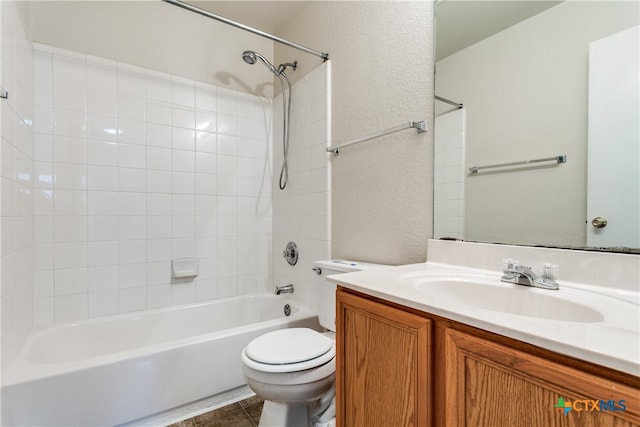 full bathroom with tile patterned flooring, vanity, toilet, and tiled shower / bath