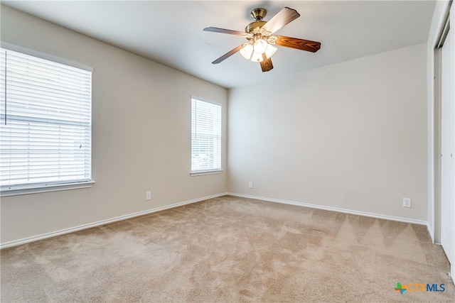 unfurnished room with light carpet and ceiling fan