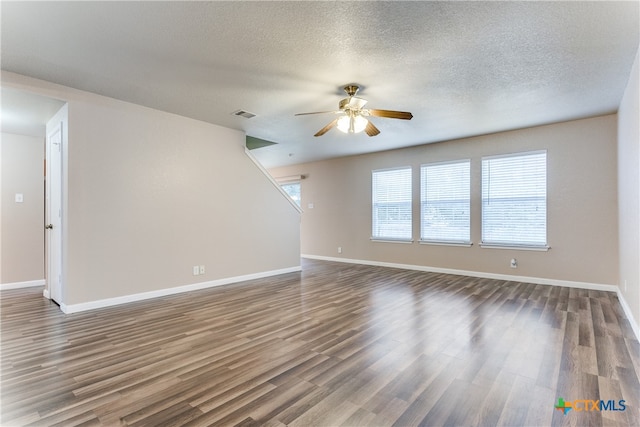 spare room featuring ceiling fan, a textured ceiling, and dark hardwood / wood-style flooring