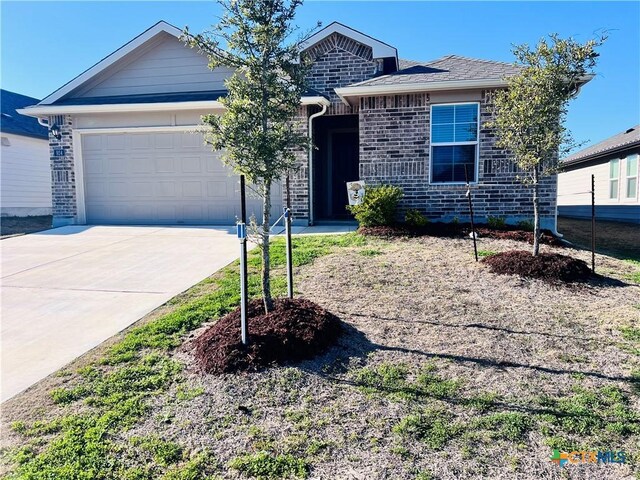 single story home featuring a front lawn and a garage