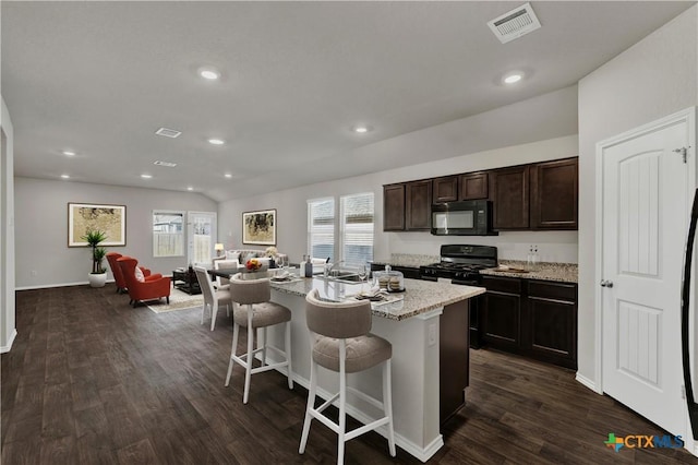 924 Adler Way, San Marcos, TX 78666 - kitchen with open floor plan, a breakfast bar, black appliances, and a healthy amount of sunlight