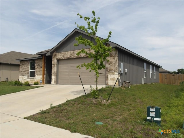 view of property exterior with stone siding, driveway, a yard, and a garage