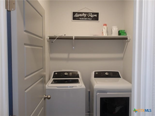 laundry area with washing machine and clothes dryer and laundry area