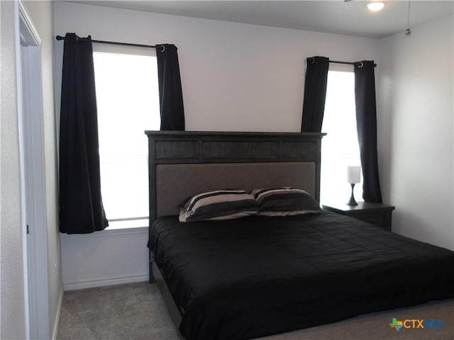 carpeted bedroom with baseboards