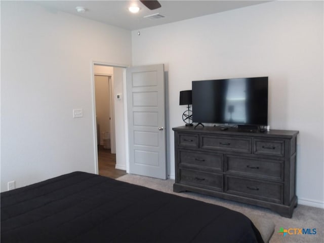 bedroom with baseboards, visible vents, a ceiling fan, and light colored carpet
