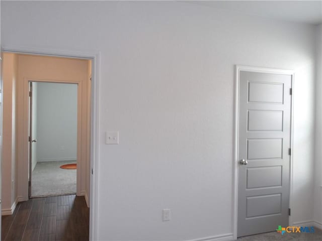 interior space with dark wood finished floors and baseboards