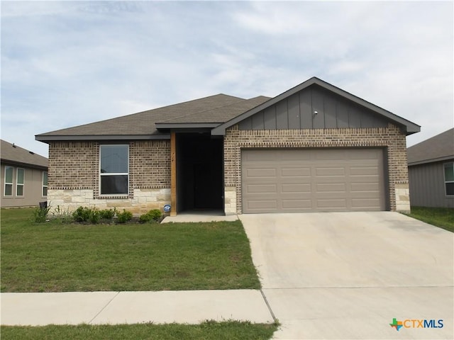 ranch-style home with concrete driveway, stone siding, an attached garage, a front yard, and brick siding