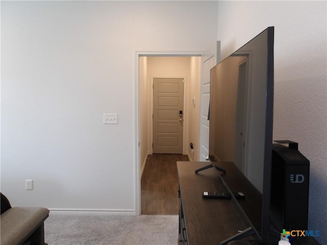 hall featuring baseboards and dark wood finished floors