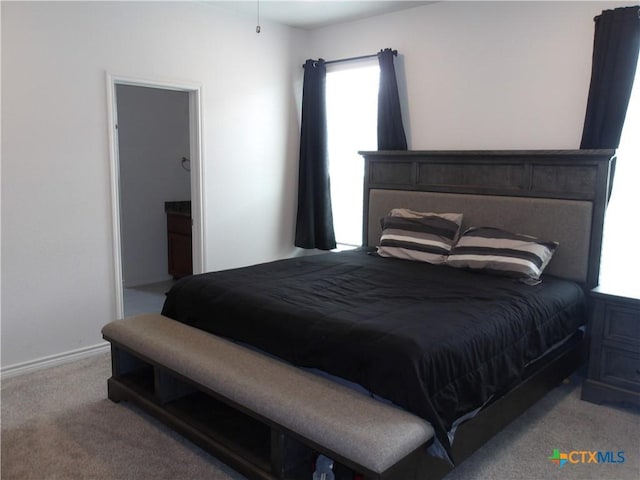 carpeted bedroom featuring baseboards