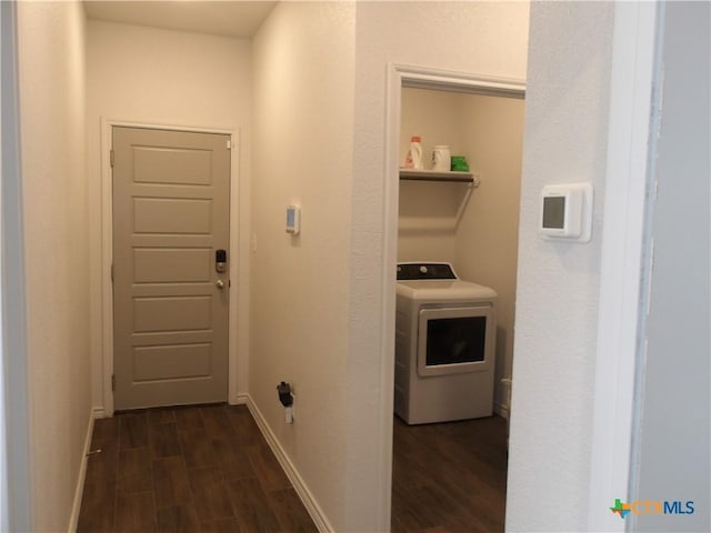 laundry room with dark wood finished floors, washer / dryer, laundry area, and baseboards