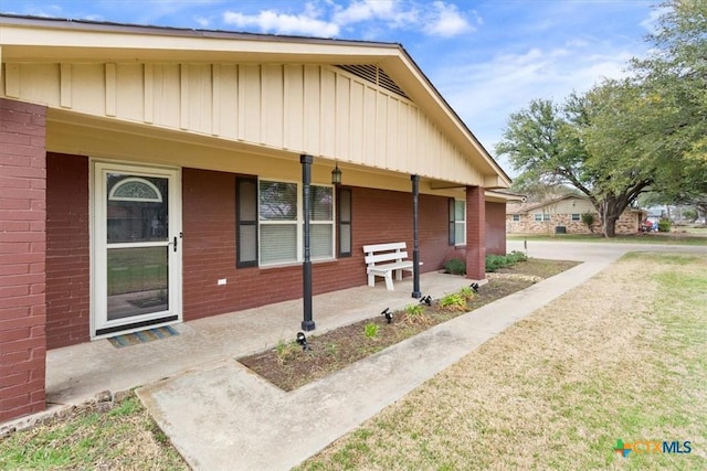 view of front of property with brick siding and a porch